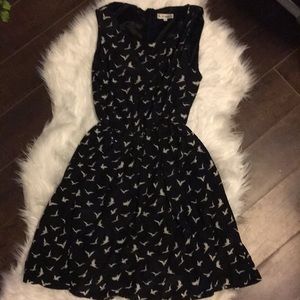 Black sleeveless dress with white birds